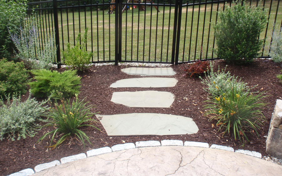 Custom patio and sidewalk installation shaping a residential outdoor space